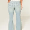 Højtaljede, lysvaskede jeans med stjerneformede lommer Højtaljede, lysvaskede jeans med stjerneformede lommer