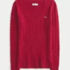 Ikonisk sweater med V-hals og kabelstrik