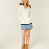 Kabelstrikket sweater med hætte og kant af imiteret pels Kabelstrikket sweater med hætte og kant af imiteret pels