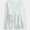 Langærmet babydoll-top med grafisk print og pinch bust Langærmet babydoll-top med grafisk print og pinch bust