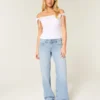 Lavtaljede, lysvaskede baggy jeans med nitter og sløjfer Lavtaljede, lysvaskede baggy jeans med nitter og sløjfer