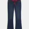 Lavtaljede, mørkvaskede bootcut-jeans med rød snøre i taljen Lavtaljede, mørkvaskede bootcut-jeans med rød snøre i taljen