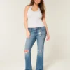 Lavtaljede, rippede bootcut-jeans i medium vask Lavtaljede, rippede bootcut-jeans i medium vask