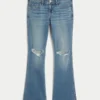 Lavtaljede, rippede bootcut-jeans i medium vask Lavtaljede, rippede bootcut-jeans i medium vask