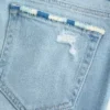 Lavtaljede, rippede, lysvaskede bootcut-jeans med broderi Lavtaljede, rippede, lysvaskede bootcut-jeans med broderi