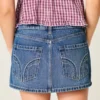 Lavtaljet mini-skort i denim med nitter Lavtaljet mini-skort i denim med nitter