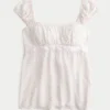 Let satin babydoll-top med bindebånd Let satin babydoll-top med bindebånd
